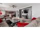 Open-concept living room with a sectional sofa, view of the kitchen, and modern entertainment center at 18484 W Westfall Way, Surprise, AZ 85374