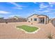 Spacious backyard featuring rock landscaping, a putting green and privacy fence at 18501 E Donato Dr, Gold Canyon, AZ 85118
