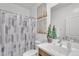 Well-lit bathroom featuring a modern vanity, toilet, and shower with patterned curtain at 18501 E Donato Dr, Gold Canyon, AZ 85118