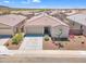Charming single-story home featuring a well-manicured front yard and a two-car garage at 18501 E Donato Dr, Gold Canyon, AZ 85118