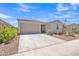 Charming single-story home with a well-manicured front yard and two car garage under a clear blue sky at 18501 E Donato Dr, Gold Canyon, AZ 85118