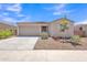 Front exterior with a desert landscape, concrete driveway, tile roof, and a two car garage at 18501 E Donato Dr, Gold Canyon, AZ 85118