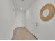 Hallway with decorative round mirror, white walls, and neutral-toned flooring at 18501 E Donato Dr, Gold Canyon, AZ 85118