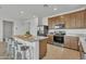 The kitchen features stainless steel appliances, a granite island, and light wood cabinetry at 18501 E Donato Dr, Gold Canyon, AZ 85118