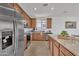 Spacious kitchen boasts stainless steel refrigerator, granite countertops, and ample cabinet space at 18501 E Donato Dr, Gold Canyon, AZ 85118