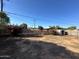 Spacious backyard featuring a fence, small storage shed, and vibrant bougainvillea at 1907 W Gardenia Dr, Phoenix, AZ 85021