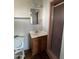 Functional bathroom featuring a vanity, toilet, and a shower with pink tile accents at 1907 W Gardenia Dr, Phoenix, AZ 85021