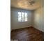 Bright bedroom with wood floors and a window offering natural light at 1907 W Gardenia Dr, Phoenix, AZ 85021