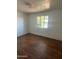 Cozy bedroom with wood floors, a window, and ample natural light at 1907 W Gardenia Dr, Phoenix, AZ 85021
