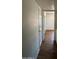 Hallway with wood floors and white doors, leading to other rooms in the home at 1907 W Gardenia Dr, Phoenix, AZ 85021
