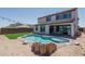 Beautiful backyard with a pool, artificial turf, and patio featuring string lights at 19690 W Marshall Ave, Litchfield Park, AZ 85340