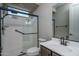 Bathroom with frameless shower, white vanity with solid surface and black fixtures at 19690 W Marshall Ave, Litchfield Park, AZ 85340