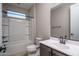 Clean and well-lit bathroom featuring a shower-tub combo and modern vanity at 19690 W Marshall Ave, Litchfield Park, AZ 85340