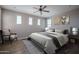 This bedroom features multiple windows, a ceiling fan, and hardwood floors at 19690 W Marshall Ave, Litchfield Park, AZ 85340