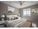 This bedroom features wood floors, a ceiling fan, and a view of the surrounding neighborhood at 19690 W Marshall Ave, Litchfield Park, AZ 85340