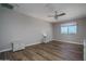 Bedroom with wood floors, a ceiling fan, and a window with a view; also features white nightstands at 19690 W Marshall Ave, Litchfield Park, AZ 85340