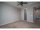 Neutral carpeted bedroom featuring ceiling fan fixture and white trim at 19690 W Marshall Ave, Litchfield Park, AZ 85340