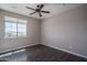 Bright bedroom with wood floors with a large window offering neighborhood views at 19690 W Marshall Ave, Litchfield Park, AZ 85340