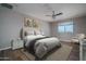 This bedroom features wood floors, a ceiling fan, and a sunny window with mountain views at 19690 W Marshall Ave, Litchfield Park, AZ 85340