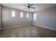 Spacious bedroom boasts plenty of natural light, ceiling fan, and sleek wood flooring at 19690 W Marshall Ave, Litchfield Park, AZ 85340