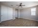 This bedroom offers a ceiling fan, wood floors, and ample closet space at 19690 W Marshall Ave, Litchfield Park, AZ 85340