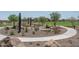 Community park area featuring walking path, mature trees, and unique desert landscaping at 19690 W Marshall Ave, Litchfield Park, AZ 85340