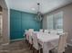 Bright dining room with paneled accent wall, chandelier, and a table set for eight at 19690 W Marshall Ave, Litchfield Park, AZ 85340