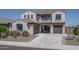 Charming two-story home with a three-car garage, desert landscaping, and a welcoming front porch at 19690 W Marshall Ave, Litchfield Park, AZ 85340
