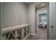 Hallway view leading to the dining room, featuring wood floors and stylish furnishings at 19690 W Marshall Ave, Litchfield Park, AZ 85340