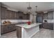Modern kitchen with stainless steel appliances, granite countertops, and pendant lighting at 19690 W Marshall Ave, Litchfield Park, AZ 85340