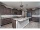 Modern kitchen with granite countertops, stainless steel appliances, and stylish pendant lighting at 19690 W Marshall Ave, Litchfield Park, AZ 85340