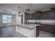 Modern kitchen featuring granite countertops, a central island, and dark wood cabinetry at 19690 W Marshall Ave, Litchfield Park, AZ 85340