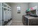 Modern laundry room features white storage, decorative fixtures and shelving above modern machines at 19690 W Marshall Ave, Litchfield Park, AZ 85340