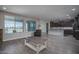 Open floor plan with wood floors, a modern kitchen in the background, and bright windows at 19690 W Marshall Ave, Litchfield Park, AZ 85340