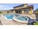 The backyard features a large pool and spa, as well as a covered patio, perfect for outdoor relaxation at 19943 E Strawberry Dr, Queen Creek, AZ 85142