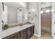 Bathroom features a long vanity with dark cabinets and tiled backsplash at 19943 E Strawberry Dr, Queen Creek, AZ 85142
