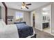 Spacious bedroom featuring soft carpet, a ceiling fan and ensuite bathroom and walk-in closet entrance at 19943 E Strawberry Dr, Queen Creek, AZ 85142