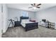 Bright bedroom with a ceiling fan, carpet, and desk area, illuminated by natural light from the window at 19943 E Strawberry Dr, Queen Creek, AZ 85142