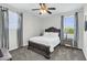 Comfortable bedroom featuring a wood-frame bed, neutral decor, and dual windows with drapes at 19943 E Strawberry Dr, Queen Creek, AZ 85142