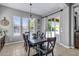 Cozy dining room with tile flooring, a sliding glass door, and a view of the backyard pool at 19943 E Strawberry Dr, Queen Creek, AZ 85142