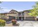 Charming two-story home with a three-car garage, and a well-kept yard with flowering bushes at 19943 E Strawberry Dr, Queen Creek, AZ 85142