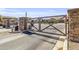 Community gate at Symphony at Cielo Noche showing stone accents and lush landscaping at 19943 E Strawberry Dr, Queen Creek, AZ 85142