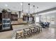 Bright, spacious kitchen with a large island, granite countertops, pendant lights, and modern stainless steel appliances at 19943 E Strawberry Dr, Queen Creek, AZ 85142