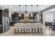 Stylish kitchen featuring stainless steel appliances, a large island with bar seating, and dark wood cabinetry at 19943 E Strawberry Dr, Queen Creek, AZ 85142