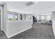 Large carpeted loft area featuring natural light, with a spacious layout and comfortable seating at 19943 E Strawberry Dr, Queen Creek, AZ 85142