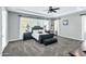 Serene bedroom with plush carpeting, a tray ceiling, and large windows at 19943 E Strawberry Dr, Queen Creek, AZ 85142
