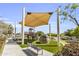 Community playground with covered seating, climbing structures, and open space for recreation at 19943 E Strawberry Dr, Queen Creek, AZ 85142