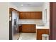 Well-lit kitchen featuring wood cabinets, stainless steel appliances, and neutral countertops, offering a functional cooking space at 204 S Valle Verde --, Mesa, AZ 85208