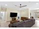 Comfortable living room features a ceiling fan, tile flooring, and a sliding glass door at 204 S Valle Verde --, Mesa, AZ 85208