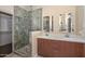 Bathroom with double sink vanity, stone shower with glass door and walk-in closet at 21532 N 65Th Ave, Glendale, AZ 85308